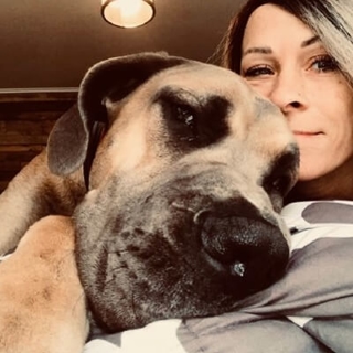 woman hugging her large dog